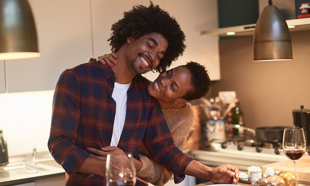 Couple cooking together in a kitchen showing acts of service as a love language