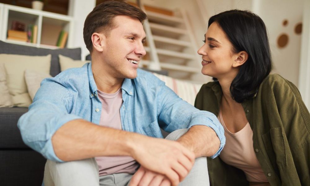 Happy couple smiling at each other, symbolizing the habit of daily affirmations in relationships